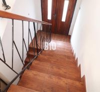 Stairs with a wooden decor floor and metal railing in a family house.