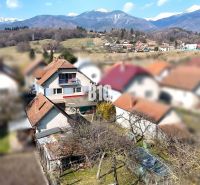 A family house in Turany with a view of snow-capped mountains and a garden.