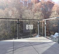 A balcony with glass railings and a forest view in Dolný Kubín, 2-room apartment.