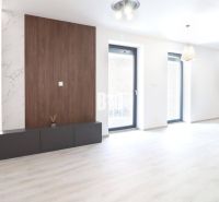 A bright interior of a 2-room apartment with a wood-patterned floor and large windows.