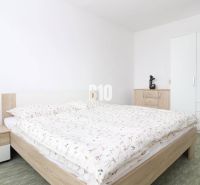 A bedroom with a wardrobe and a double bed in a 3-room apartment. The wardrobe has a mirror.