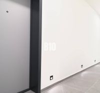 A hallway in a 2-room apartment with light-colored tiles and doors.