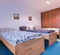 A bedroom in a 3-room apartment with three beds and built-in wardrobes.
