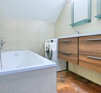 Bathroom with a shower, double sink, washing machine, and cabinet in a 3-room apartment.