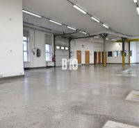 Bright production spaces with concrete floors and high ceilings.