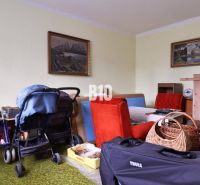 Interior with a stroller, furniture, and paintings in a family house.