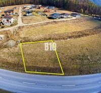 Land for sale in a new neighborhood between houses, suitable for living.