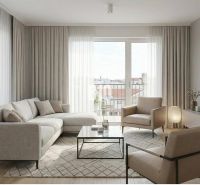 Living room with a sofa, armchairs, and a wooden decor floor in a 2-room apartment.