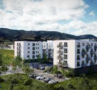 A new building on Košútska Street in Martin surrounded by greenery and mountains.