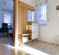 Entrance hall in a family house with wooden decor and a view of the study.