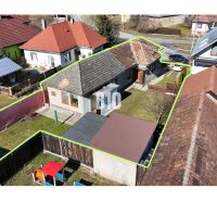 Family house in Ľubela with a garden, gazebo, and storage spaces. Traditional roof and fencing.