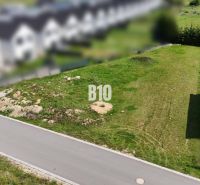A plot suitable for living in Diakova with an access road and surrounding development.
