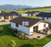 A family house in Diaková with a large garden and terrace, with mountains in the background.
