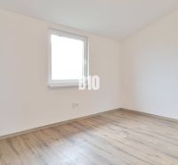 An empty room with a wooden floor in a family house.