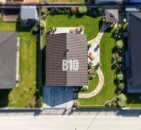 Aerial view of a family house in Diaková with a landscaped garden and a walkway.