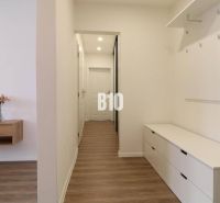 Hallway of a 3-room apartment with a wooden decor floor and storage spaces.