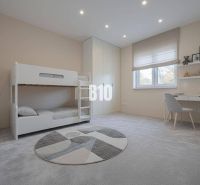 Children's room with a bunk bed and a desk in a family house.