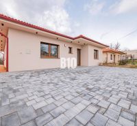 A family house in Beladice with a shingle roof and a large paved driveway.