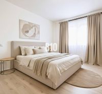 A bright bedroom with neutrally toned textiles and a wood-patterned floor in a family house.