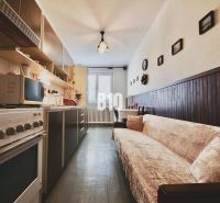 A cozy kitchen with a sofa and decorations in a 3-room apartment.
