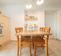 Dining room with a wooden table and chairs in a 3-room apartment.