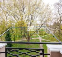 View from the balcony of a 3-room apartment in Nitra overlooking a green park with pathways.