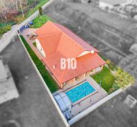 Aerial view of a family house in Nitra with two roofs and a swimming pool.