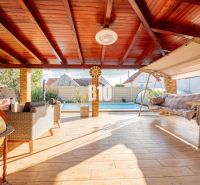 A spacious terrace in a family house in Nitra with a swimming pool and a swing.