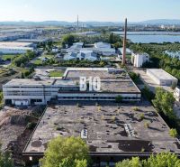 Production facilities in Levice surrounded by greenery and an industrial zone.