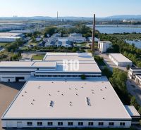 Production facilities in Levice surrounded by nature and a body of water.