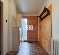 A hallway in a family house with wooden elements and furniture.