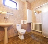 Bathroom in a family house with a sink, toilet, and shower. Tile decor.