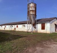 Production premises in the town of Turá with an extensive yard and older buildings in the background.