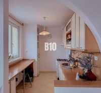 A kitchen in a 3-room apartment with a kitchenette and a bar counter.