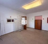 Commercial spaces with empty shelves and storage cabinets.