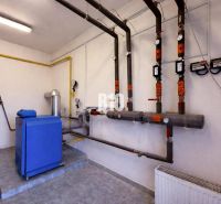 A boiler room with piping and meters in commercial premises.