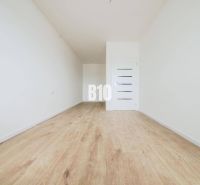 Empty room, wooden floor, white walls, interior door of a 2-room apartment.