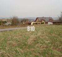 Plots - housing in the village of Rosina, grassy land with the surroundings of rural houses.