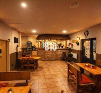 The interior of the building with wooden furniture and a bar, a pleasant atmosphere for sitting.