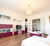 Living room in a 3-room apartment with a wooden decor floor and stylish furniture.