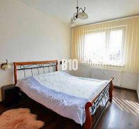 Bedroom with a double bed and a wooden decor floor, 3-room apartment.