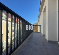A balcony with a view of buildings in Žilina, suitable for a 2-room apartment.