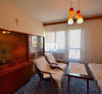 Living room in a family house with retro furniture and curtains on the window.