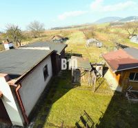 A family house in Žilina with annexes, a garden, and a view of the surrounding countryside.