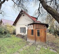 A family house in Kotešová with a wooden shelter and a garden in the autumn season.
