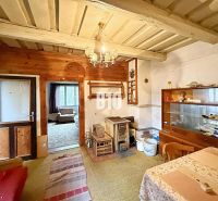 Interior of a family house with traditional furnishings, tiles, carpets, and wooden decor.