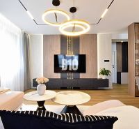 Living room in a 3-room apartment with a wooden decor floor and stylish lighting.