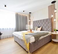 A bedroom in a 3-room apartment with curtains and a wooden decor floor.