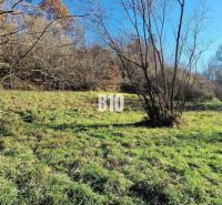A grassy plot in Bytča surrounded by forest, suitable for living.