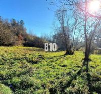 Sunny residential plot with grass and trees in Bytča, ideal for nature lovers.